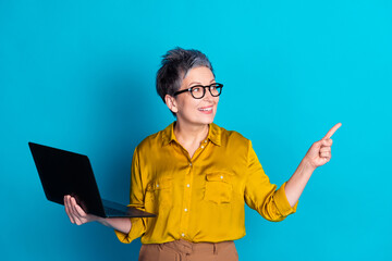 Sticker - Photo of adorable good mood lady dressed shirt eyewear typing modern gadget showing empty space isolated blue color background