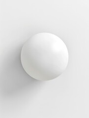 Wall Mural - A white ball is sitting on a white wall