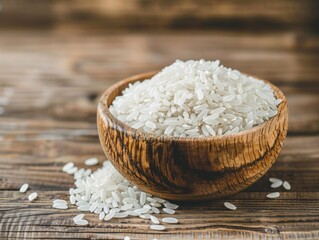 Wall Mural - A bowl of white rice is sitting on a wooden table. The bowl is wooden and has a rustic feel to it