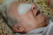 © berna_namoglu - face of old man or woman with eye bandage