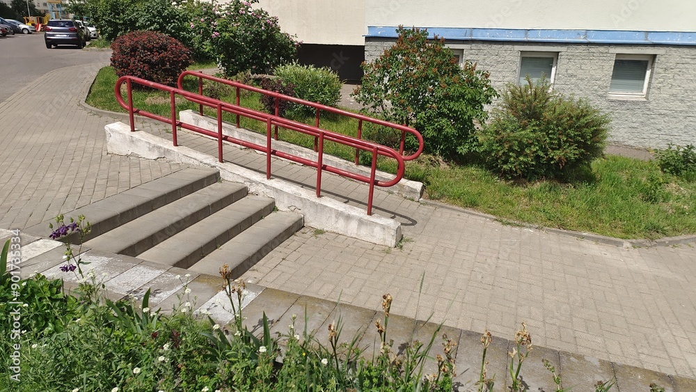 Small Incline Ramp With Railing An inclined ramp with a tiled floor and metal handrails was built to ...