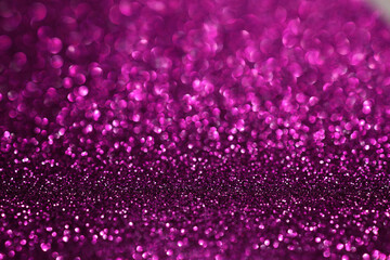 Wall Mural - Pink magenta glitter bokeh background with defocused sparkling lights, abstract shiny texture. Holiday lights.