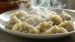 © MakoPoko - A plate of steaming dumplings, the hot vapor curling upwards, emphasizing their deliciously cooked perfection on a plain background.