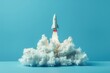 © MK - A small rocket soaring through the air, perfect for use as a symbol of innovation and progress