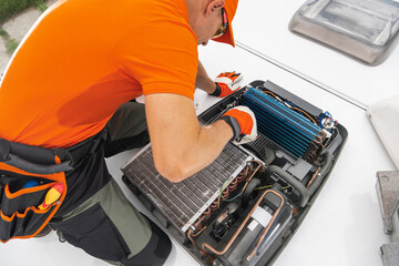 Wall Mural - RV Motorhomes Technician Performing Maintenance on Rooftop Air Conditioning Unit During Daylight