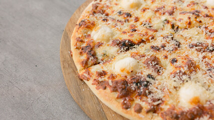 cheese pizza served in a pizzeria, close-up on the right side of the photo