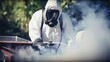 © Stavros - Gardener carefully sprays strong pesticide to manage annoying insect population in grassy garden. Man in special protective clothes cautiously applies pesticide to control insect population in garden