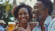 © Michela - Uomo di colore, con la figlia,  alza un boccale di birra e sorridono felici