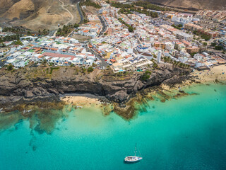 Wall Mural - white sandy beach and blue water in morro jable, south of fuerteventura, canary islands