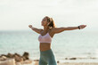 © milanmarkovic78 - Woman Enjoying Music During Morning Workout On The Beach