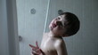 © Marco - Young boy sad and contemplative in shower, emotional bath time, wet hair and skin, child with thoughtful expression, bathroom scene, introspective moment, child depression, deep in thought
