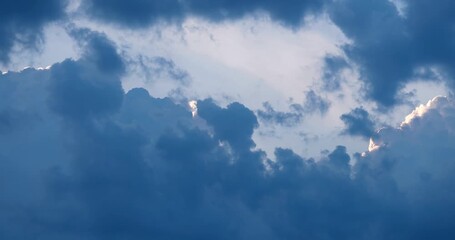 Wall Mural - contrasting sky with clouds in motion. natural endless cumulus clouds before a storm in the evening