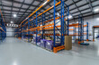 © alhim - Spacious Modern Warehouse Interior With Organized Racks Full of Goods.The interior of a bright and spacious warehouse features tall, sturdy shelving units that are meticulously organized.