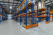 © alhim - Industrial Warehouse Interior Featuring Organized Shelving Units and Inventory Storage.The interior of a spacious industrial warehouse showcases a systematic arrangement of shelving units. Tall racks