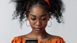 © Stock Source - Young AfricanAmerican woman using a smartphone for online education isolated on a plain background highlighting learning technology and personal growth