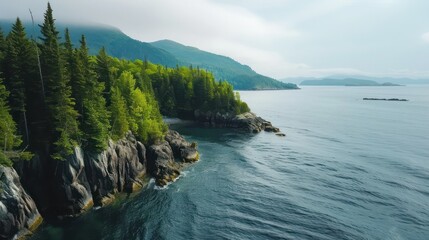 Leinwandbilder - A beautiful view of a lake with mountains in the background. The water is calm and the sky is cloudy