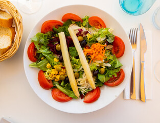 Sticker - Portion of fresh mediterranean salad made of olives, corn, lettuce, beetroot, asparagus, carrot and beetroot.