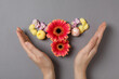 © Atlas - Uterus, flowers and female hands on gray background, top view