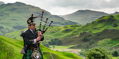 Bagpiper in Traditional Scottish Attire Playing in Serene Green Highland Landscape