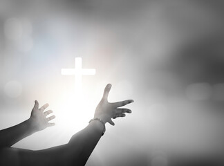 Wall Mural - close up of human hands pointing with finger at christian cross symbol