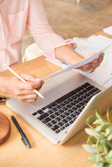 Wall Mural - Vertical Businesswoman reading financial graph charts business info with computer laptop. Vertical horizon Women hands using laptop on office desk. Close up hands of business woman working office