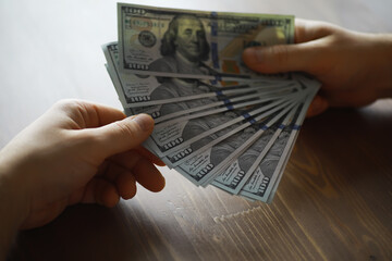 Hands Exchanging US Dollar Bills, Financial Transaction, Money Transfer Concept