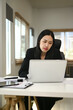© Prathankarnpap - Serious asian businesswoman in black suit analyzing work results on laptop screen