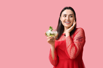 Sticker - Beautiful young woman with glass of fresh mojito on pink background