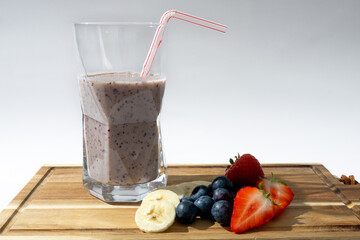 Smoothie With Strawberries, Blueberries and Bananas on Cutting Board