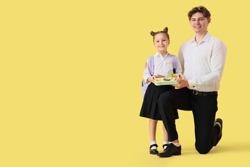 Sticker - Little girl with school lunchbox and her father on yellow background