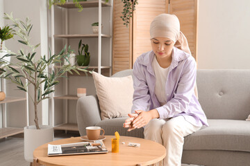 Sticker - Young Asian woman after chemotherapy rolling joint with weed on sofa at home