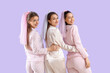 © Pixel-Shot - Young woman with her bridesmaids in pajamas on lilac background. Hen Party