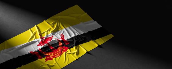 Flag of Brunei. Fabric textured Brunei flag isolated on dark background. 3D illustration