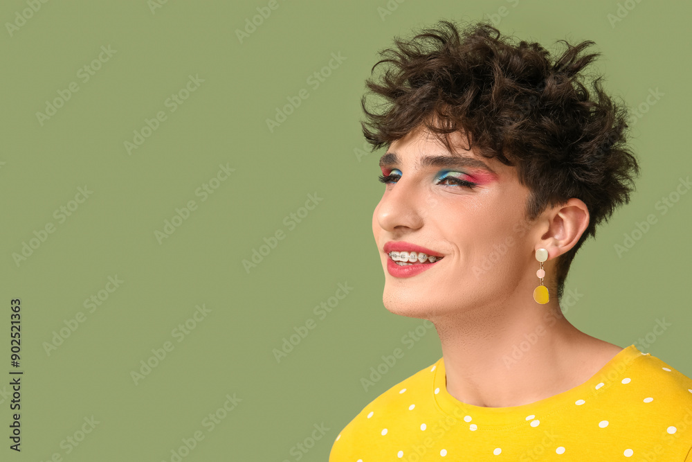 Young transgender woman on green background, closeup
