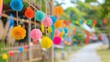 © AlgoCreative - Colorful pom-pom decorations hanging, creating a vibrant atmosphere along a festive outdoor path, perfect for celebrations.