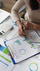 Canvas Print - Teamwork of two businesswomen talking Brainstorming and calculations with a calculator on assessment data in the conference room. Focus on business growth and point to financial accounting chart.