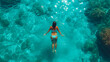 © EwaStudio - Aerial view of woman swimming in sea.