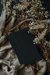 Poster - A book sits on top of a stack of colorful cloth, awaiting use or storage