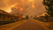 © NE97 - Bushfire smoke billowing into sky behind houses along main street of country town in hunter valley, conveying a sense of danger and emergency
