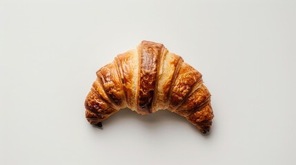 Wall Mural - A croissant is sitting on a white background. The croissant is golden brown and has a slightly crispy texture. Concept of indulgence and comfort