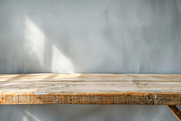 Poster - Empty rustic wooden tabletop against a textured wall in soft sunlight, perfect for product display