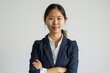 © vefimov - A woman in a business suit is posing for a photo. She is wearing a white shirt underneath her blue jacket