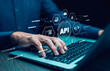 © Bussarin - Businessman using laptop with API  icon on a virtual screen in the background of technology device internet, API Application Programming Interface connects services on the internet data communication.