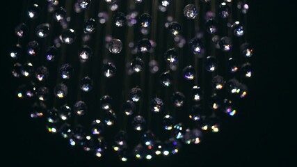Wall Mural - crystals closeup. crystal modern chandelier detail on black background. hanging diamonds with blinki