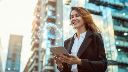 Poster - Beautiful smiling business woman in a suit holding a tablet with a digital cloud in the air on business center background. Digital cloud service, app, network, security, database, interface, support