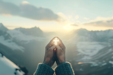 Wall Mural - Hands Holding High a Glowing Cross on a Mountain Peak - Spiritual Symbolism Against a Majestic Summit Photo