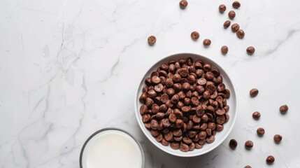 Chocolate cereal and milk in a white bowl on a white marble table