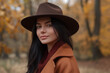 © Klay - sophisticated woman black hair,  in stylish autumn attire posing in golden forest