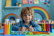 © S photographer - Caucasian boy coloring with crayons in classroom.