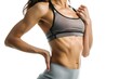 © Anna - Cropped image of sporty woman with muscular abs in black underwear Isolated on white background